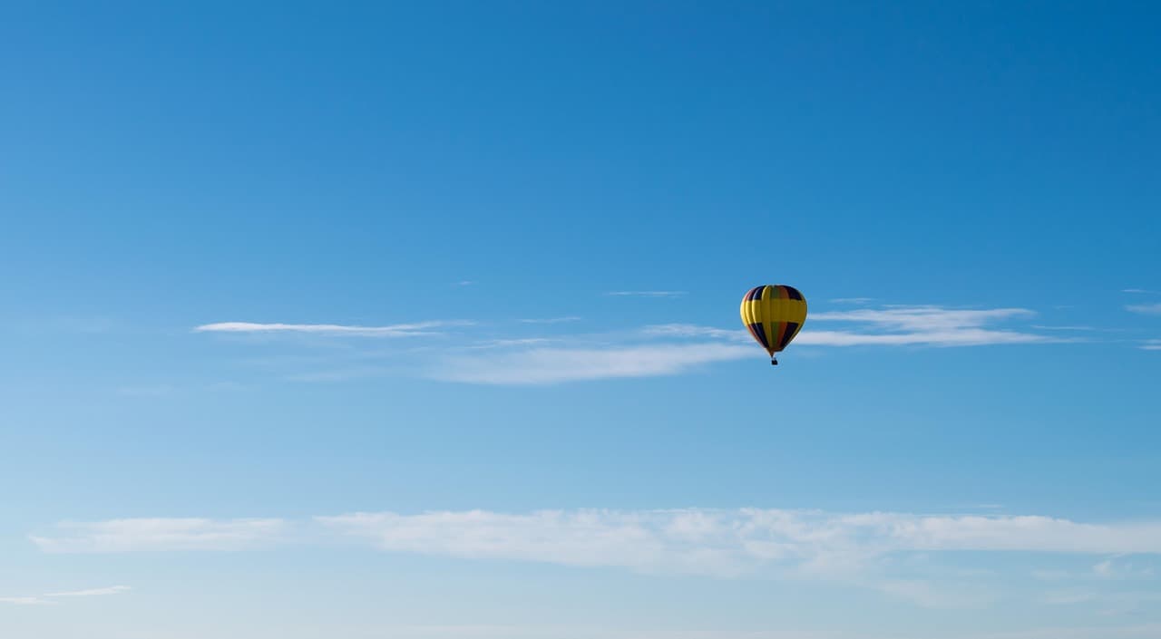 Damn Yankee Balloons' hot air balloon aloft in a clear blue sky