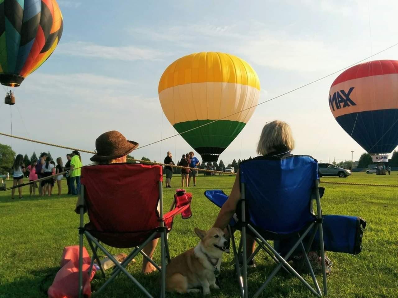 Spectators watching hot air balloons at a festival